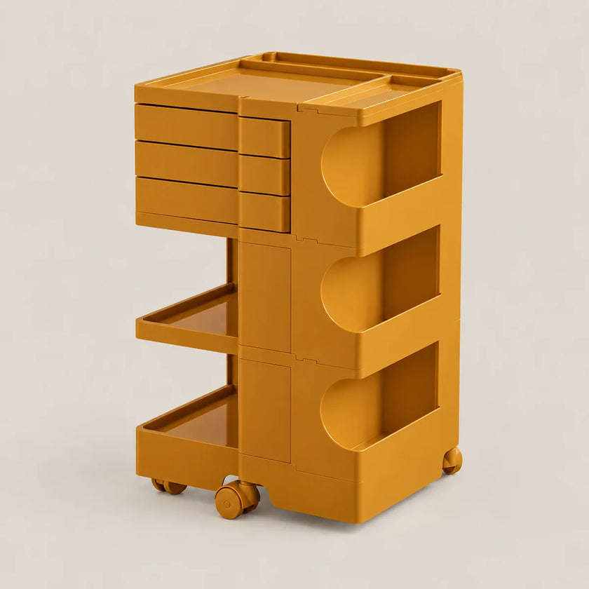 A mustard yellow modular rolling storage cart with three drawers, two open shelves, and wheels, shown on a light beige background.