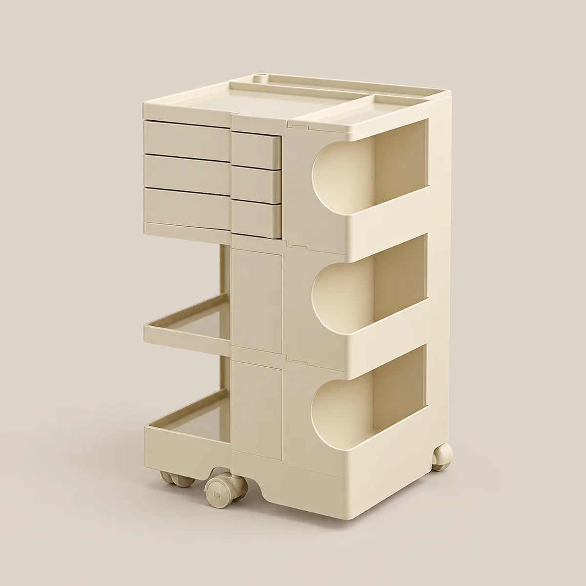 A cream-colored modular plastic storage cart with three tiers, featuring a top drawer unit, open shelves, and caster wheels, set against a solid beige background.