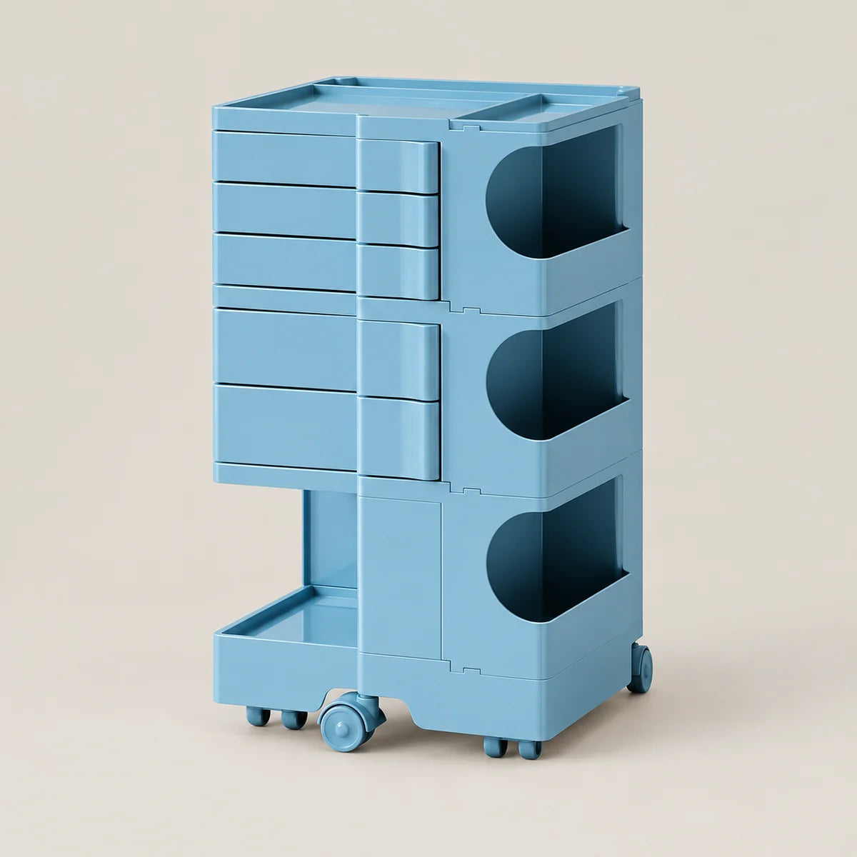A light blue modular plastic storage cart with three tiers, featuring drawers on the top and two open cubbies on the middle and bottom, set against a solid beige background.