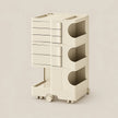 A cream-colored modular storage cart with multiple drawers and open cubbies, shown on a plain beige background.