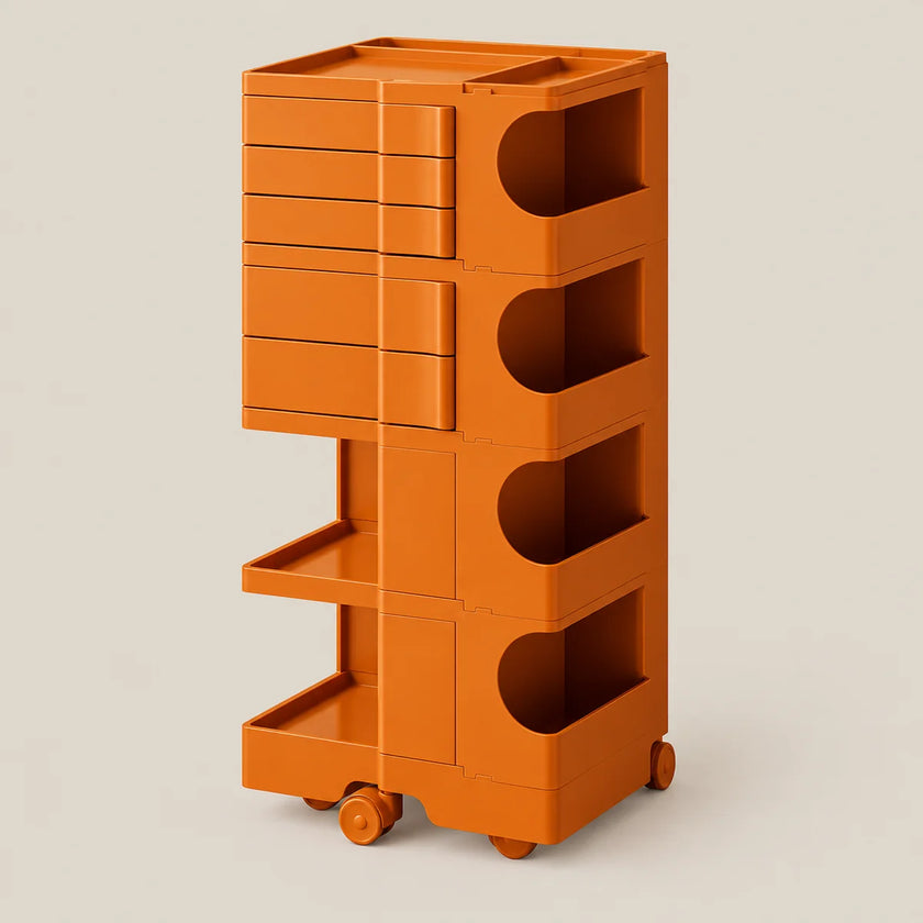 An orange modular rolling storage cart with five tiers, featuring drawers on the upper left, open shelves, and wheels at the base, shown against a solid light beige background.