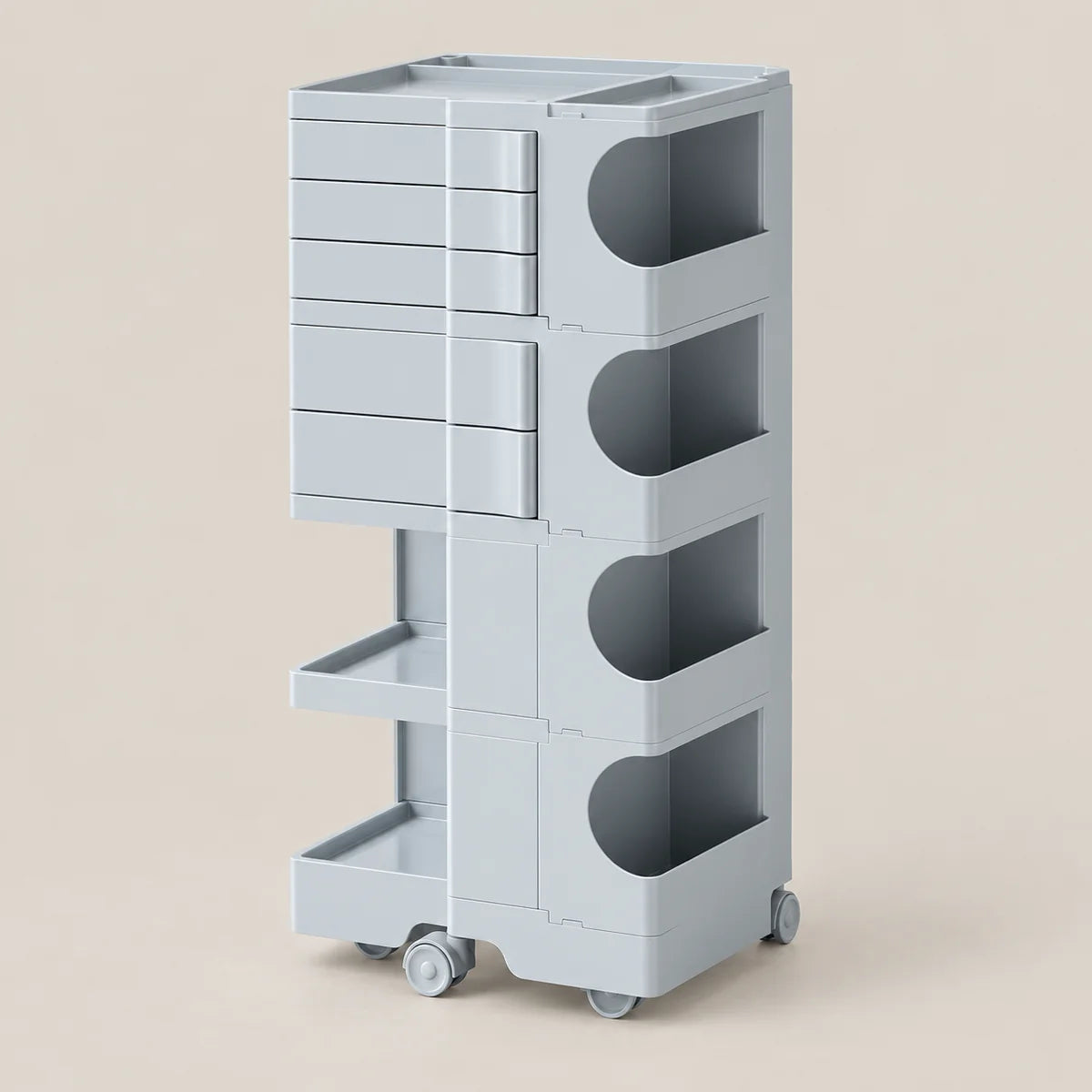 A light gray modular rolling storage cart with four tiers, featuring a stackable drawer unit on the left, three open circular shelves on the right, and a lower open shelf, set against a solid beige background.