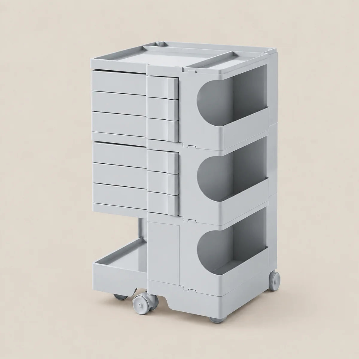 A light gray plastic rolling storage cart with three tiers of drawers on the left, open curved shelves on the right, and casters at the base, shown on a solid beige background.