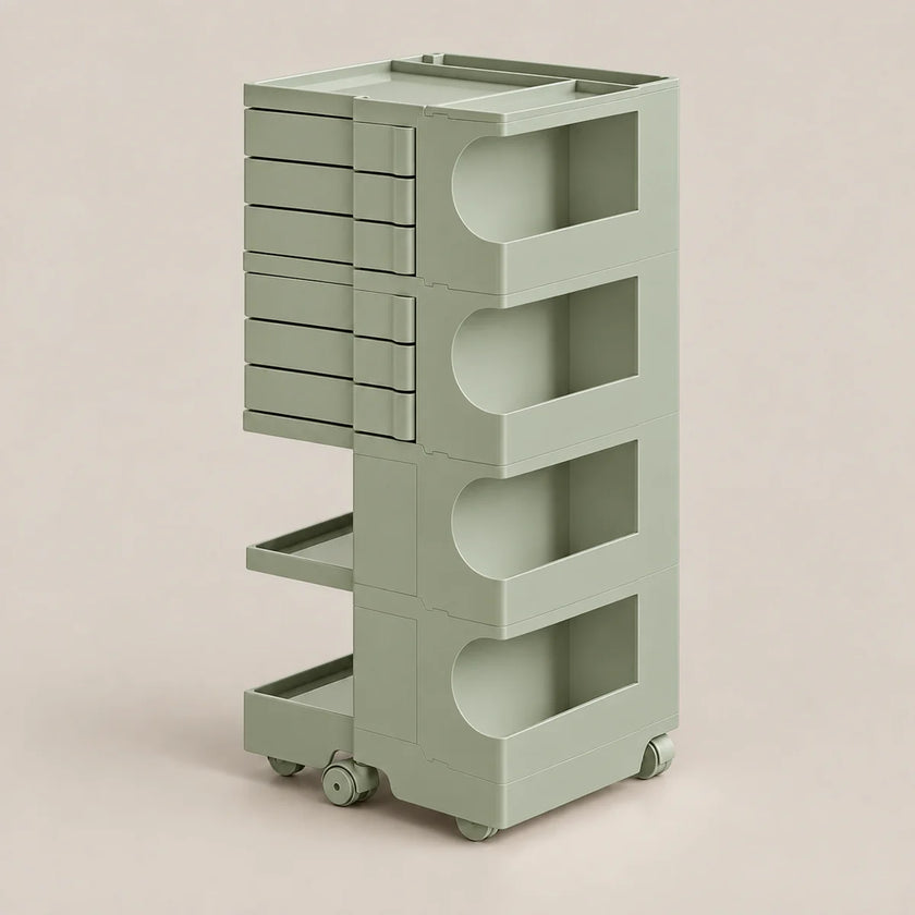 A light sage green rolling storage cart with multiple drawers and open shelves, shown on a plain warm beige studio background.