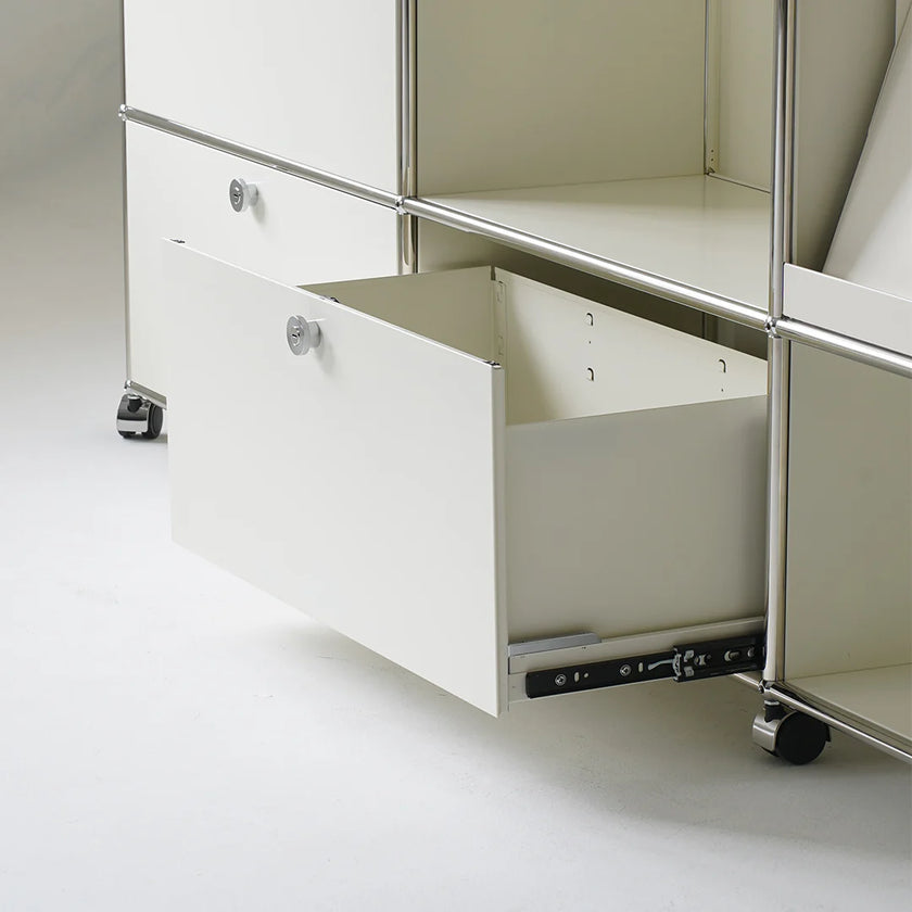 White storage unit with a drawer pulled out on a light gray background