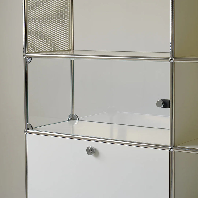 Metal shelving unit with glass shelves on a neutral background
