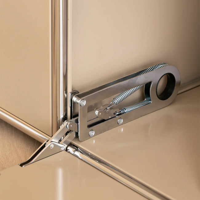 Metal door closer on a beige door