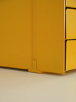 Close-up of a yellow metal box with a white background