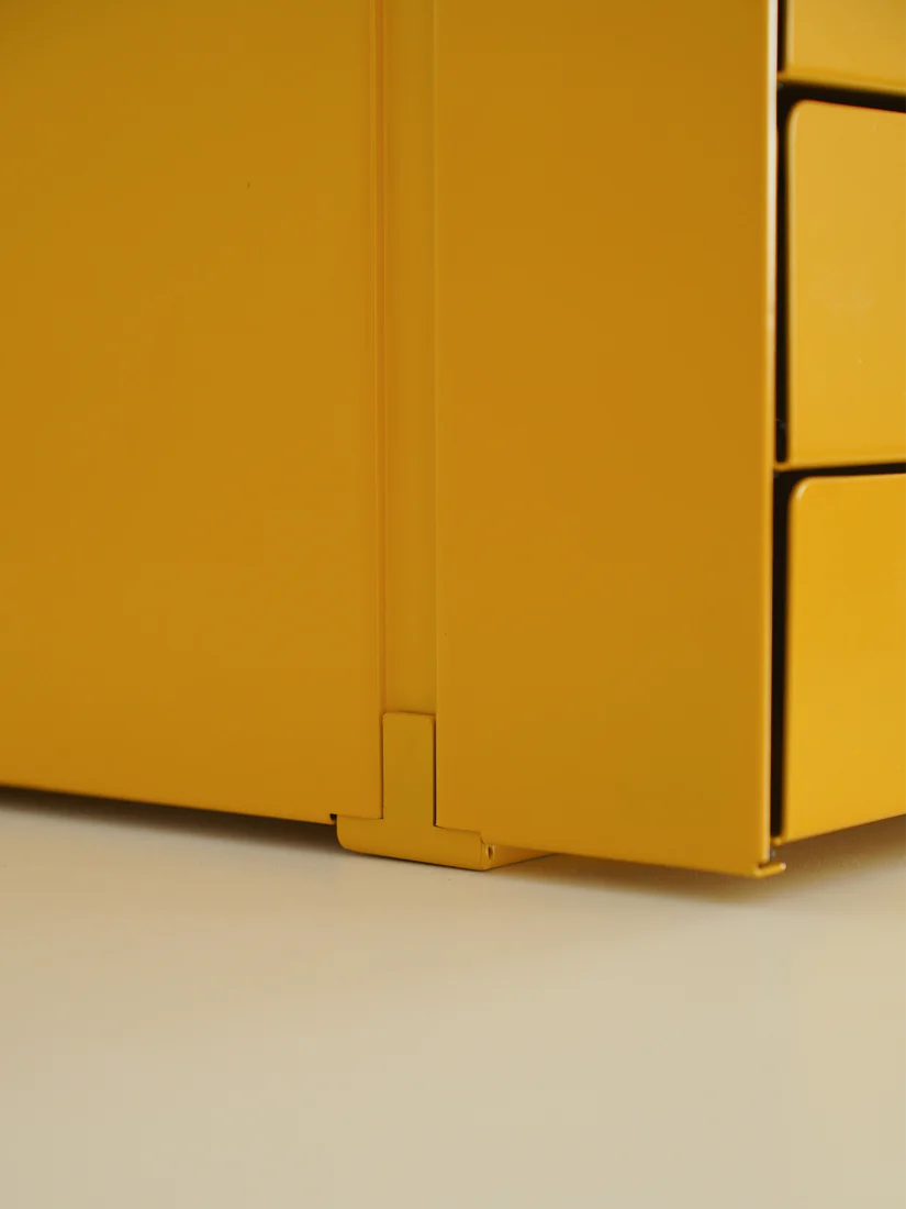 Close-up of a yellow metal box with a white background