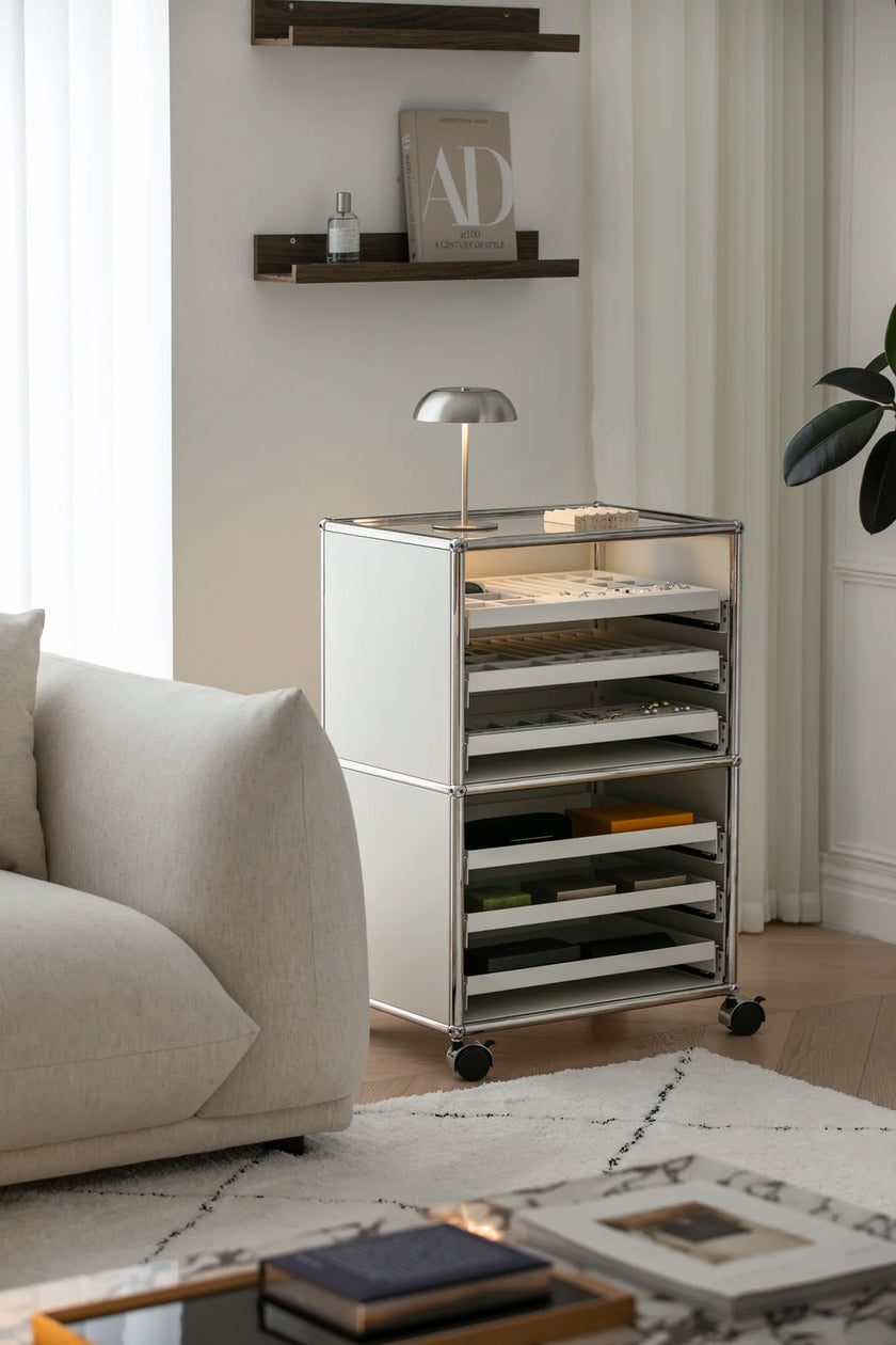Modern metal storage cart in a living room setting with a sofa and coffee table.