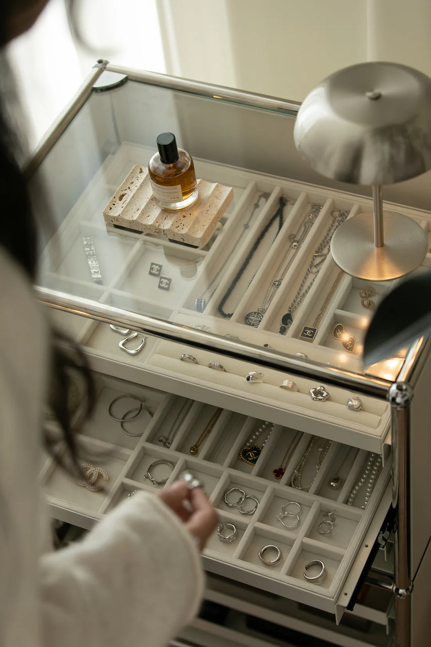 Jewelry box with various jewelry items and a lamp inside