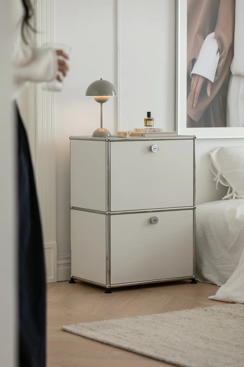 Modern bedroom with a side table and decorative items.