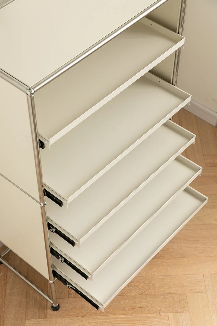 White metal shelving unit with multiple shelves on a wooden floor.