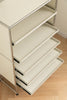 White metal shelving unit with multiple shelves on a wooden floor.