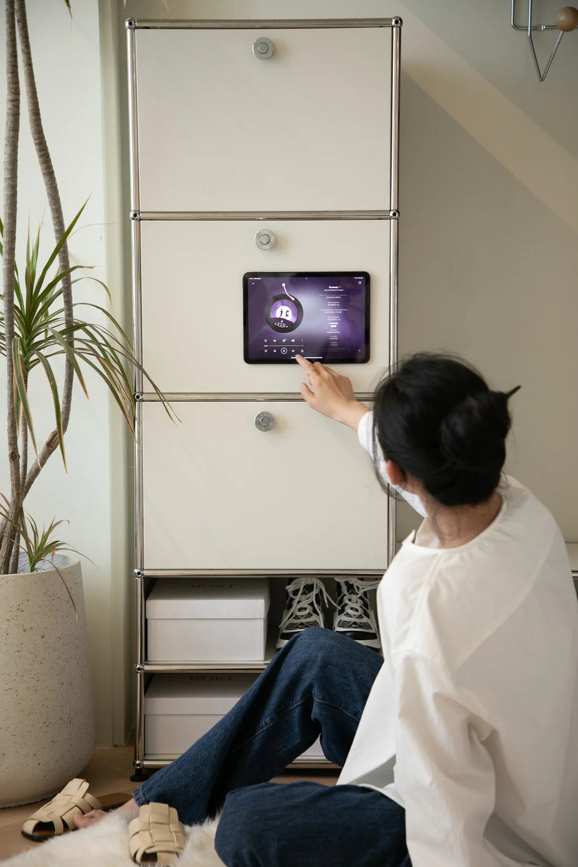 Lady interacting with a smart home device on a wall-mounted screen