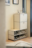 White shoe cabinet with open door showing shoes inside, placed against a wall.
