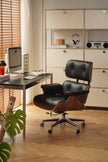 Black office chair in a home office setting with a desk and computer.
