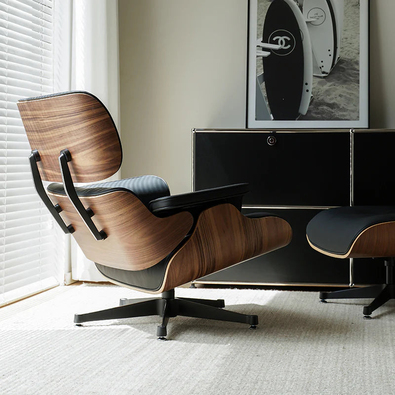 Modern wooden chair in a room with a television and framed picture on the wall.