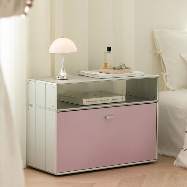 Modern nightstand with pink drawer and white lamp in a bedroom setting