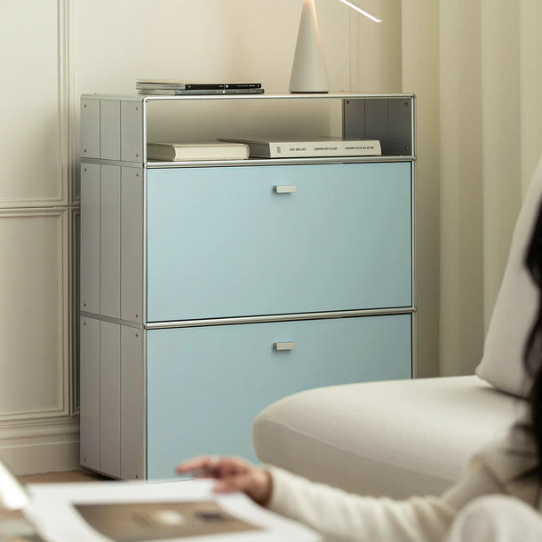Light blue filing cabinet with metallic accents in a room setting.