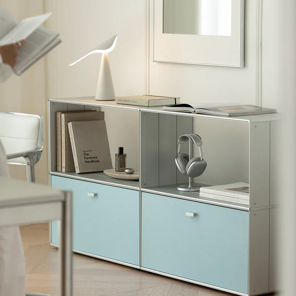 Modern office setup with a light blue storage unit, chair, and desk.