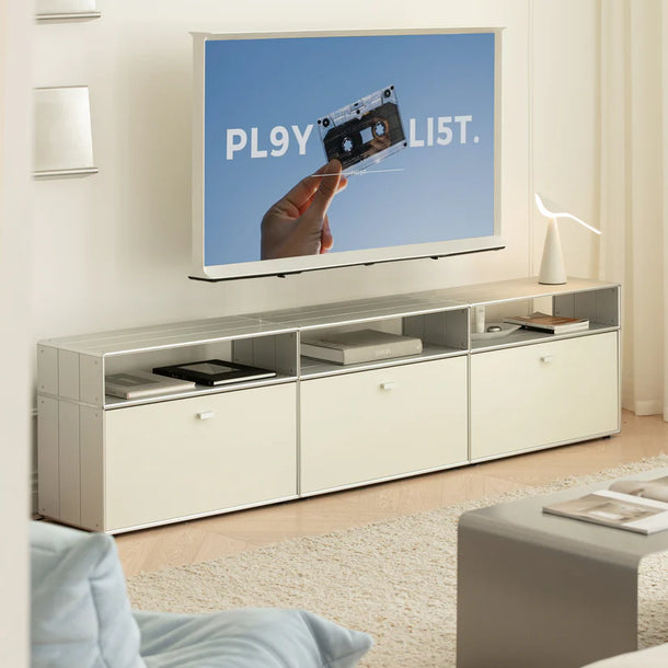 Modern living room with a TV displaying a playlist on a white entertainment console.
