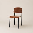 Wooden chair with black legs on a beige background