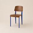 Chair with wooden seat and backrest and blue metal legs on a beige background