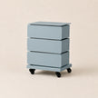 Light blue three-drawer rolling cabinet on a beige background
