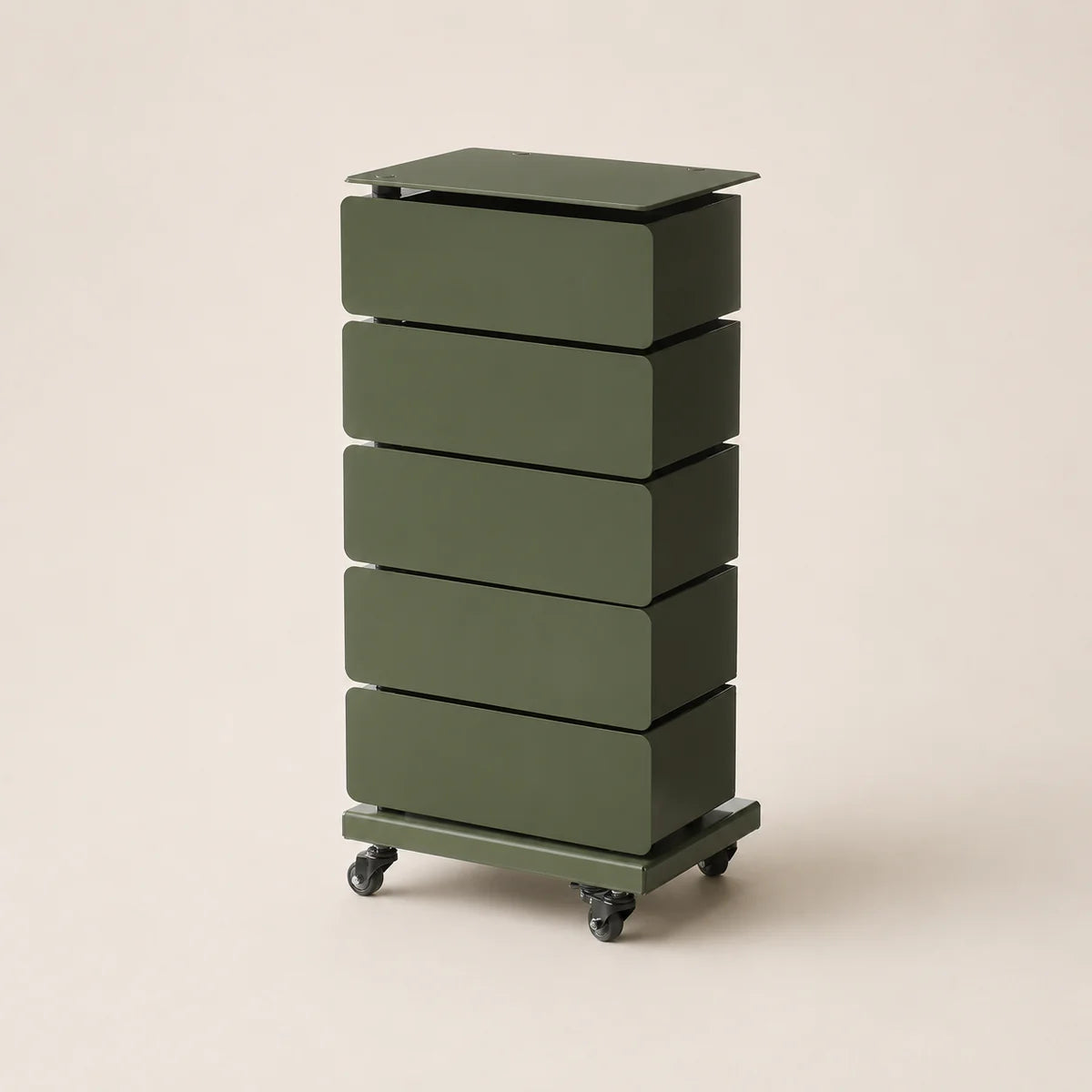 Green cylindrical storage unit with four drawers on a beige background
