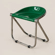 A modern folding stool with a glossy green molded seat and a chrome metal frame, shown on a solid light beige background.