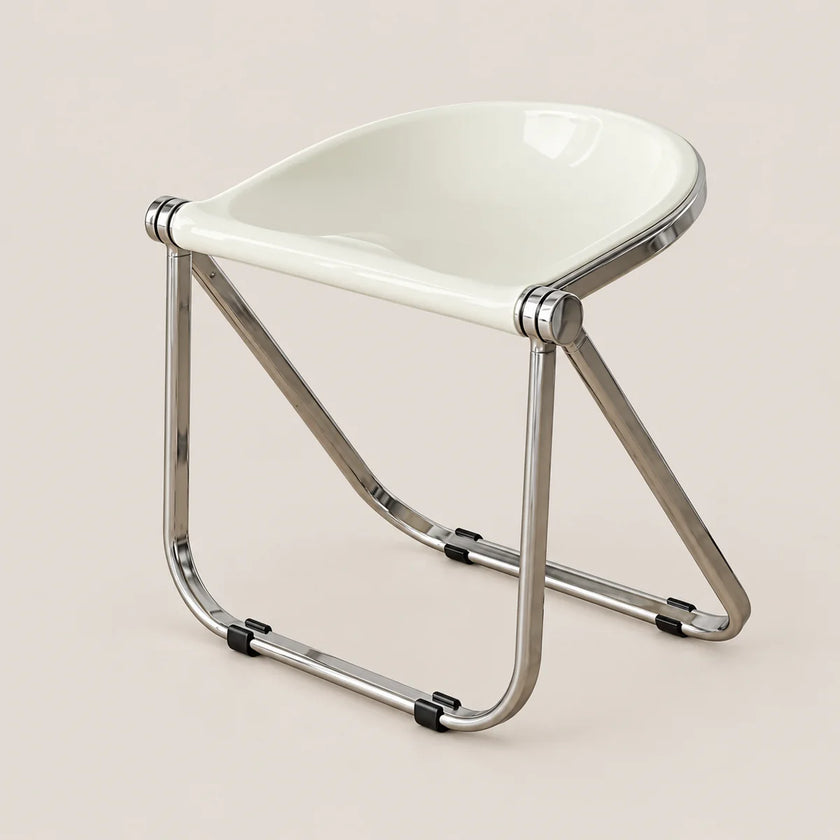 A modern folding chair with a glossy white molded seat and a polished chrome metal frame, shown on a solid light beige background.