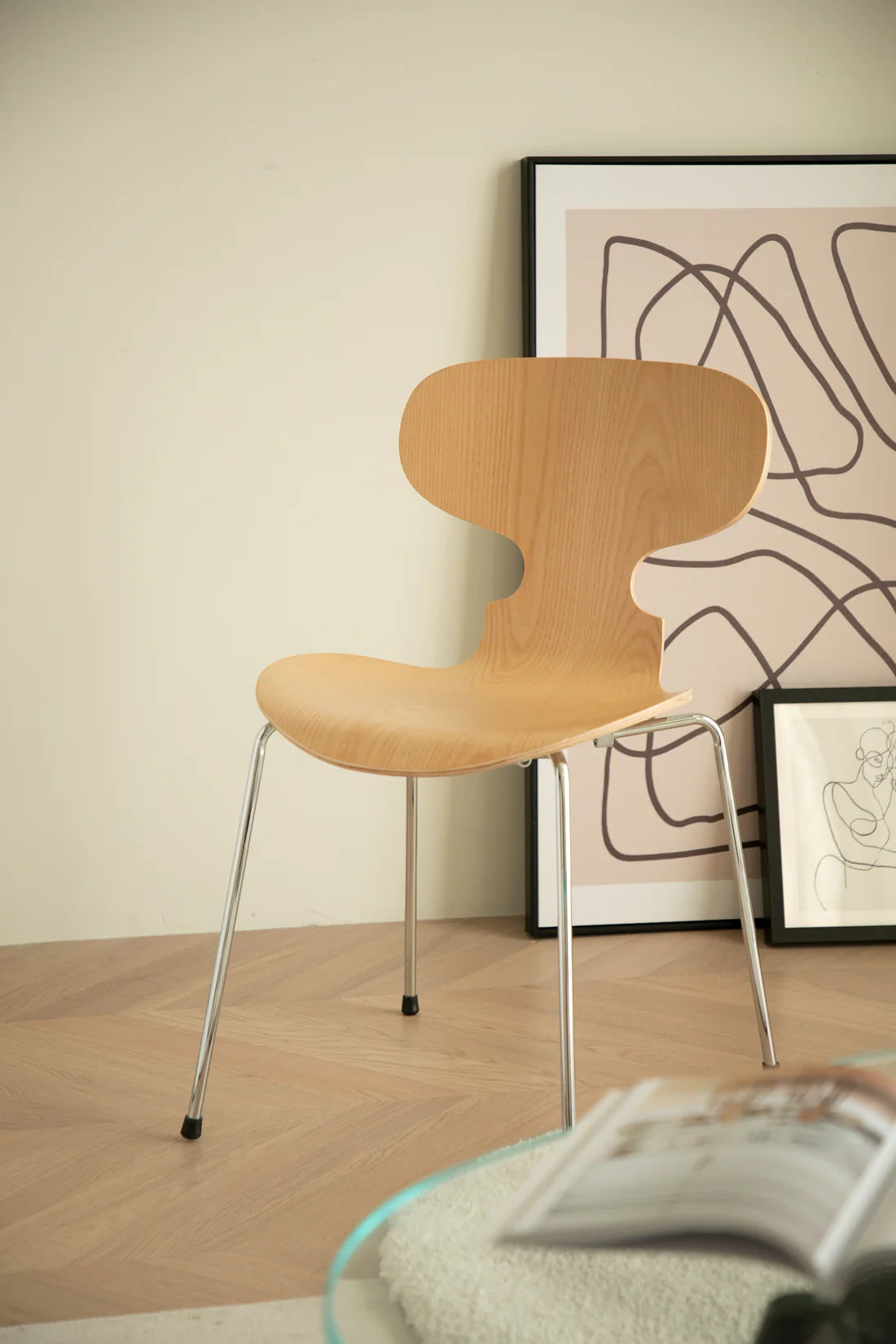 Wooden dining chair in a room with abstract art on the wall