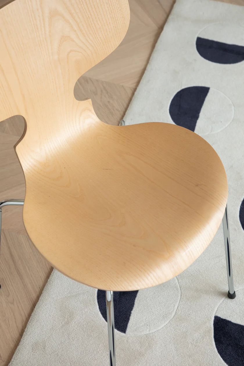 Wooden dining chair on a patterned rug