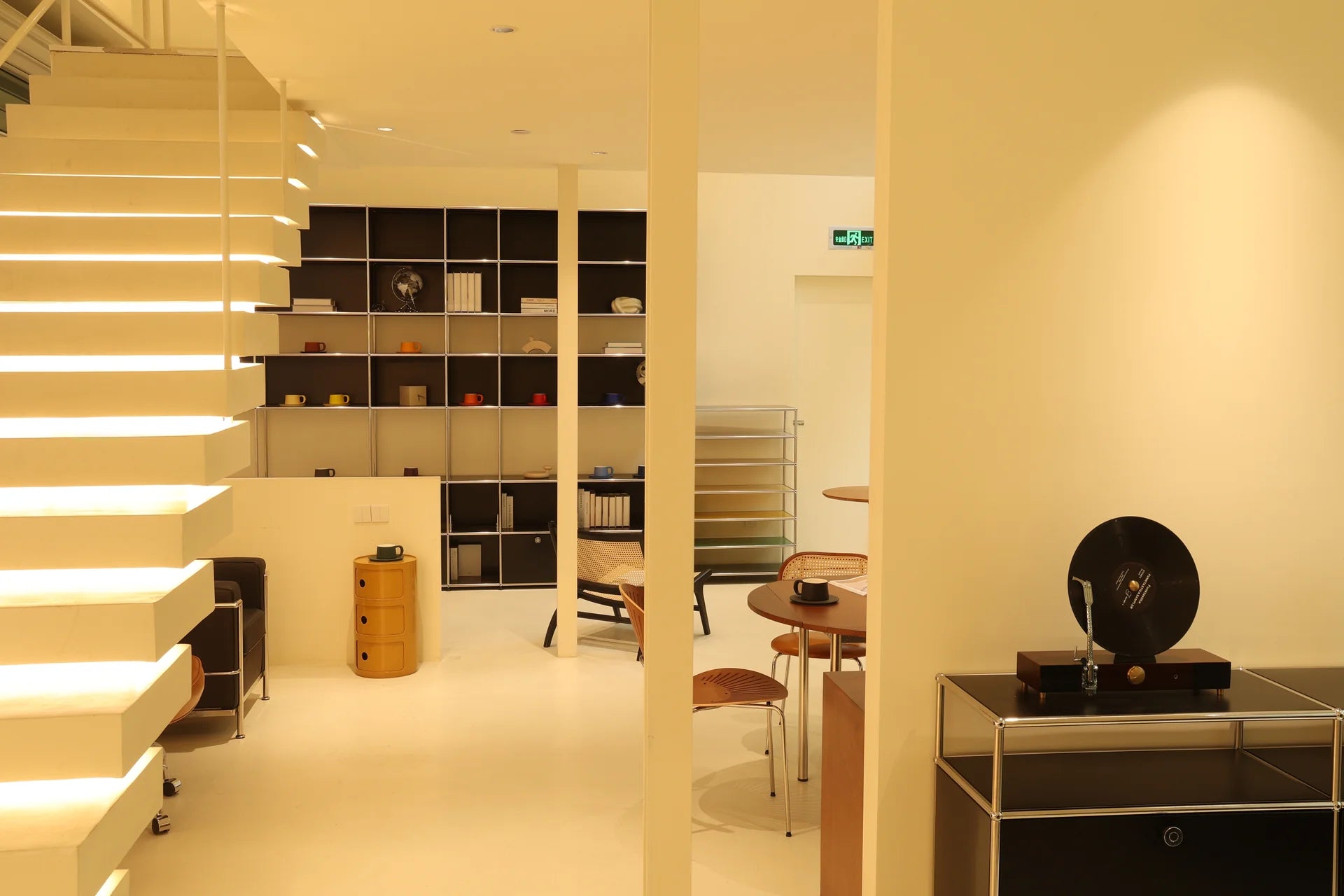 Modern interior with shelves, a chair, and a table with decorative items.