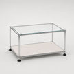 A modern rectangular glass-top storage table with a chrome metal frame and a white lower shelf, shown on a clean white background.