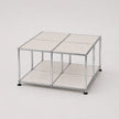 A modular storage cube organizer with a chrome silver metal frame, white metal panels, and black feet, shown on a light gray background.