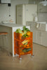 Orange plastic containers rolling cart with vegetables in a modern kitchen