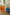 Three colorful plastic containers storage carts in a room setting.