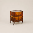 Transparent brown side table with wheels on a beige background