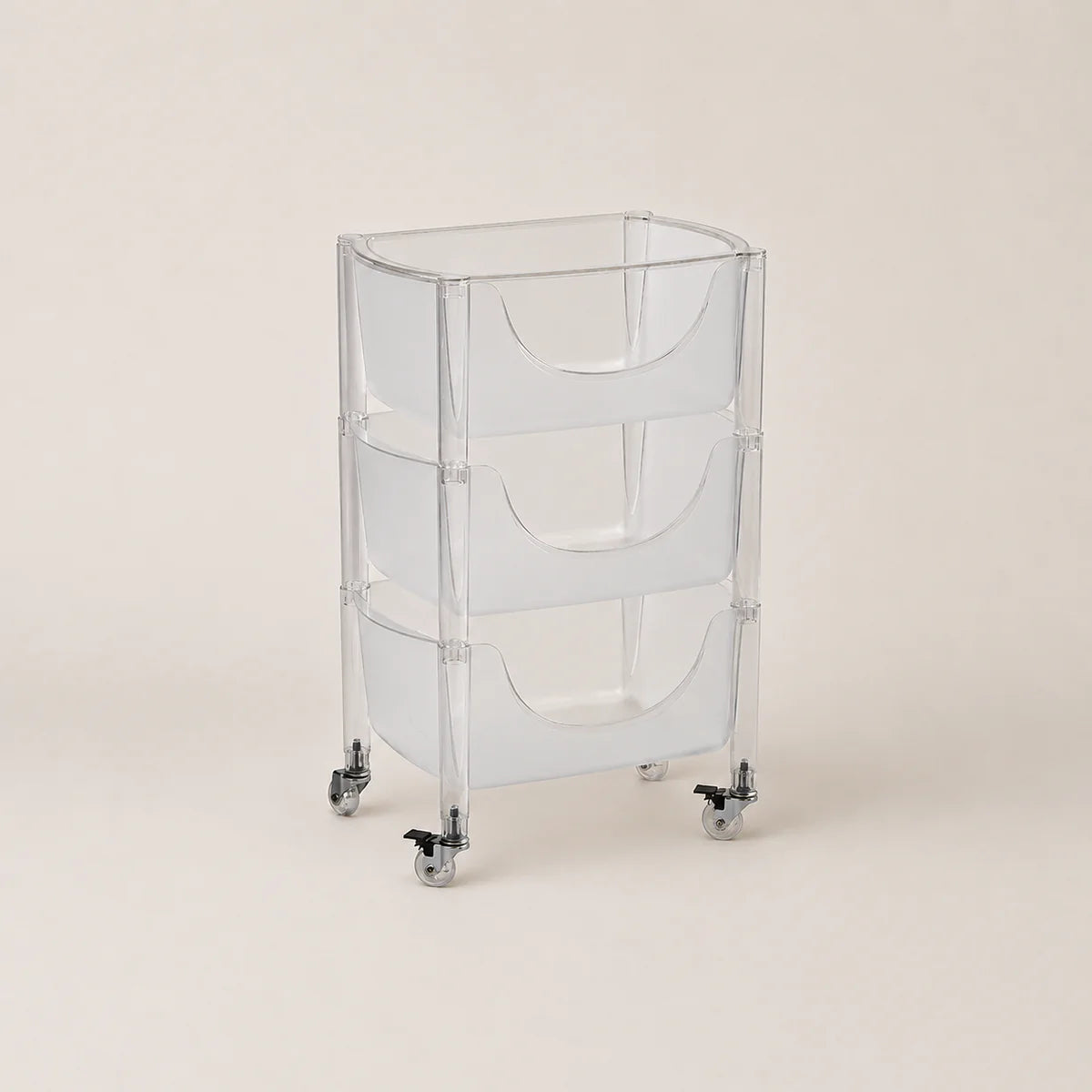 Clear plastic rolling cart with three shelves on a beige background