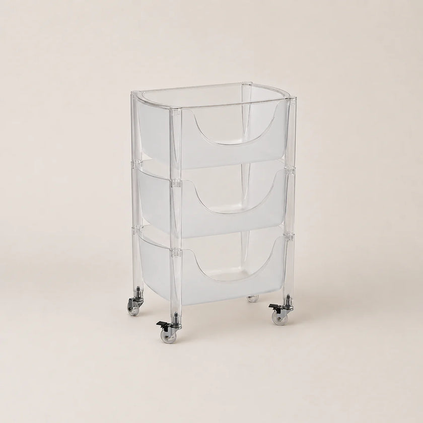 Clear plastic rolling cart with three shelves on a beige background