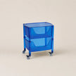 Blue rolling cart with transparent design on a beige background