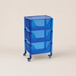 Blue rolling cart with three shelves on a beige background