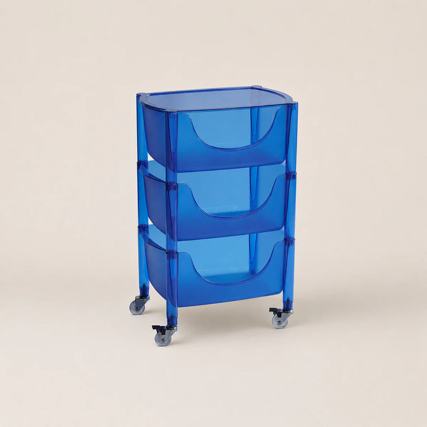 Blue rolling cart with three shelves on a beige background