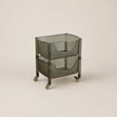Glass serving cart on wheels with a beige background