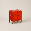 Red storage cart with wheels on a beige background
