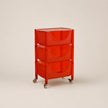 Red storage cart with three drawers on a beige background
