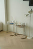 Modern interior with small side tables and a floor lamp on a wooden floor.