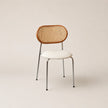 Chair with wicker backrest and white seat on a beige background
